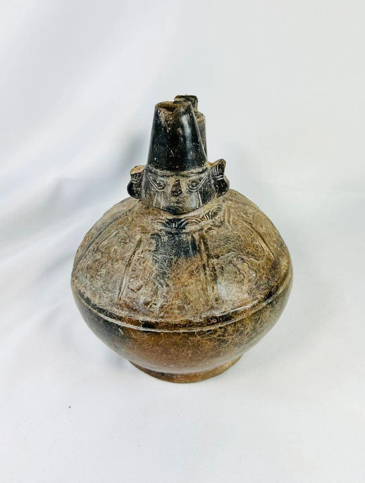 Pre-Columbian Sicán blackware ceramic vessel, upright view showing glossy surface and decorative firing patterns.