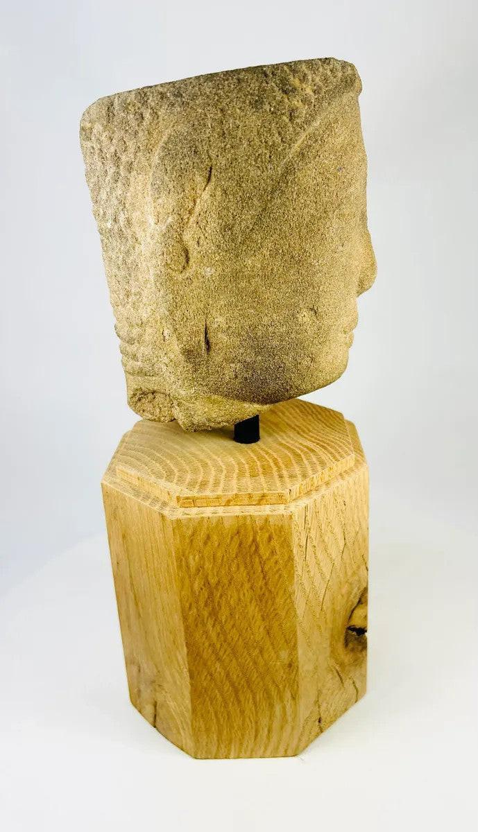 Right-side angled view of Khmer Sandstone Buddha Head Fragment from 12th-Century Angkor Period Cambodia, showing serene facial features and detailed carving on sandstone, mounted on wooden base – Relic and Rarity.
