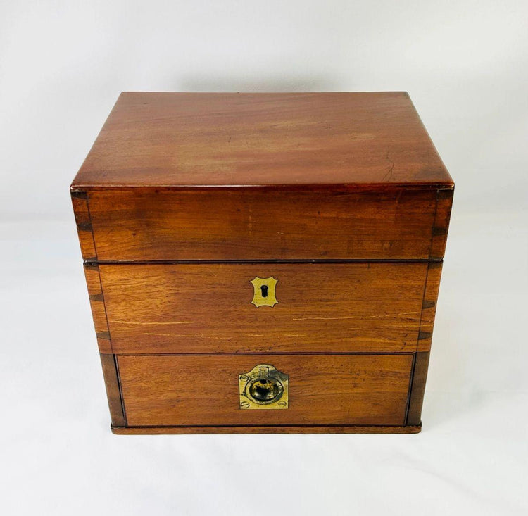 Closed antique Victorian apothecary box made of polished mahogany wood with brass keyholes and fittings, late 19th century chemist’s kit.