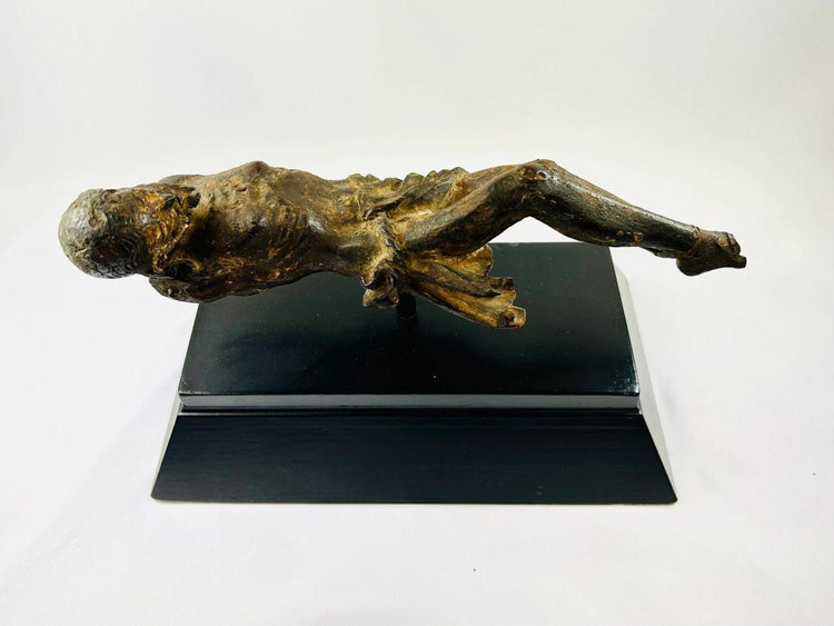 Side view of a 17th-century European wooden crucifix depicting Christ on a black museum display base, showing detailed Baroque carving and natural aged patina — Relic & Rarity.