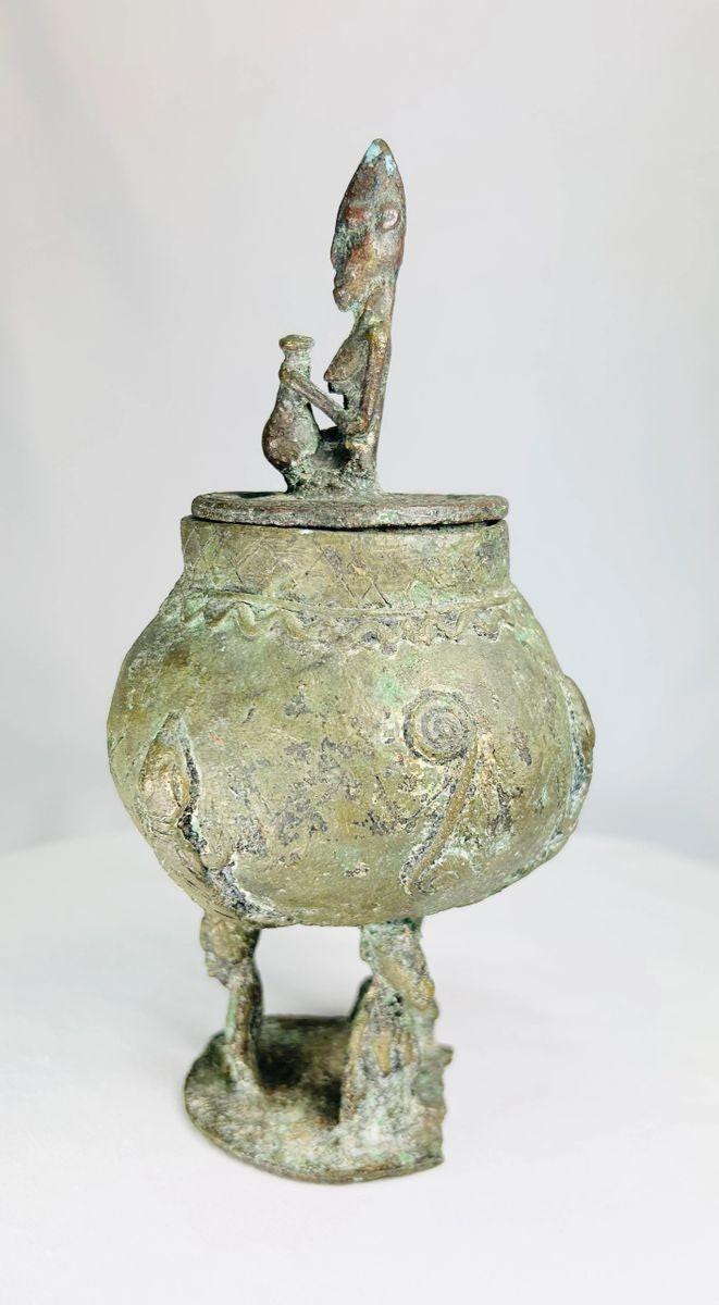 Dogon spiritual bronze container with anthropomorphic design and aged patina.