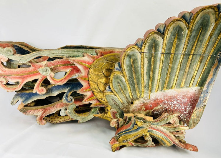 Detailed close-up of Qing Dynasty phoenix relief sculpture carved from camphor wood, with vivid red, blue, and gold gilded plumage representing the Fenghuang – Relic and Rarity.