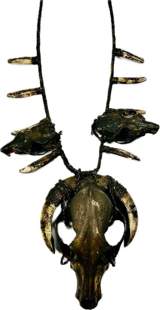 Tribal ritual necklace featuring animal skulls and pig teeth woven on twine cord, 19th–early 20th century