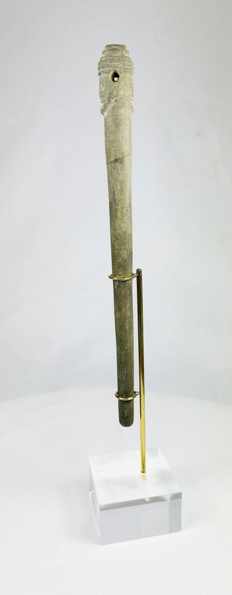 Side view of Bronze Age Bactrian stone figure featuring dual-faced Janus head and smooth weathered surface.