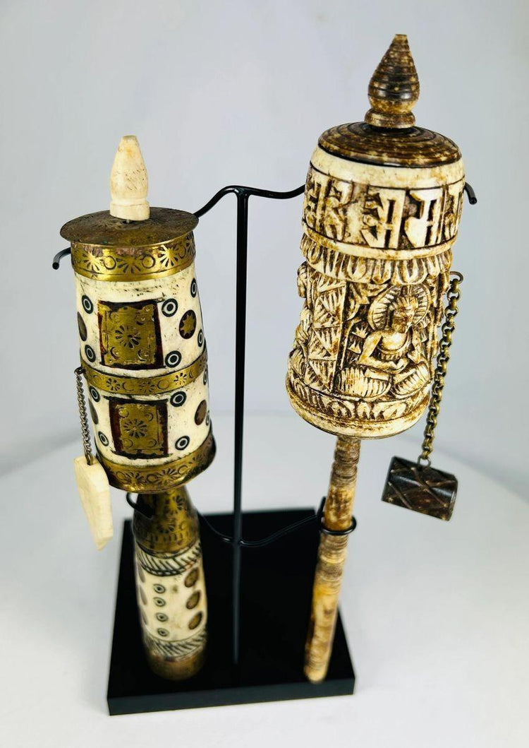 Tibetan Buddhist prayer wheels with Buddha figure and mantra script