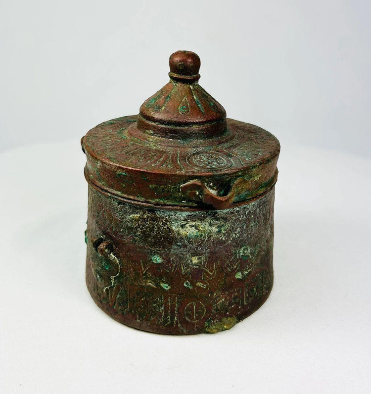 Islamic bronze inkwell featuring engraved floral and geometric motifs