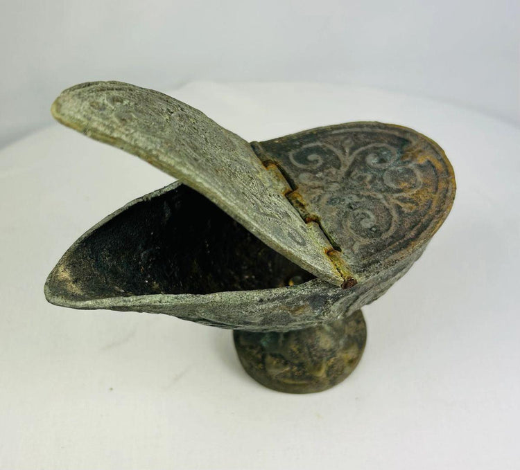 Bronze oil lamp with hinged lid partially open, exposing dark interior, curved spout, and engraved Han Dynasty patterns.