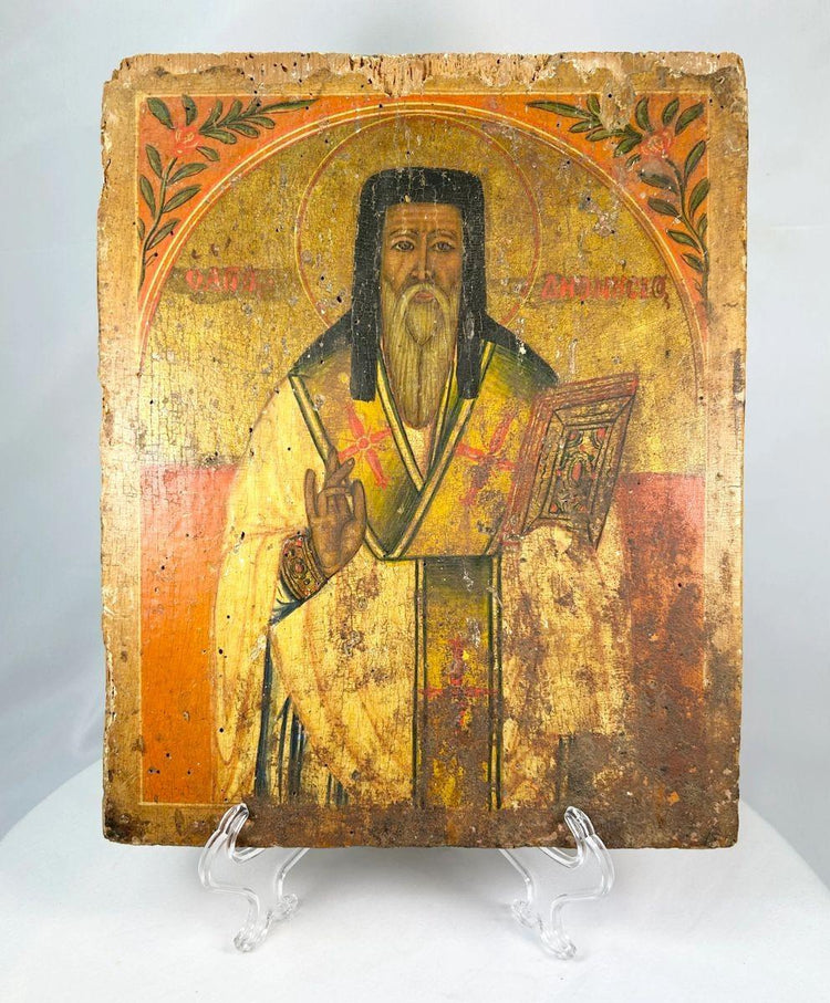 Front view of an 18th-century Russian Orthodox icon depicting a saint holding a Gospel book, hand-painted on an aged wooden panel.