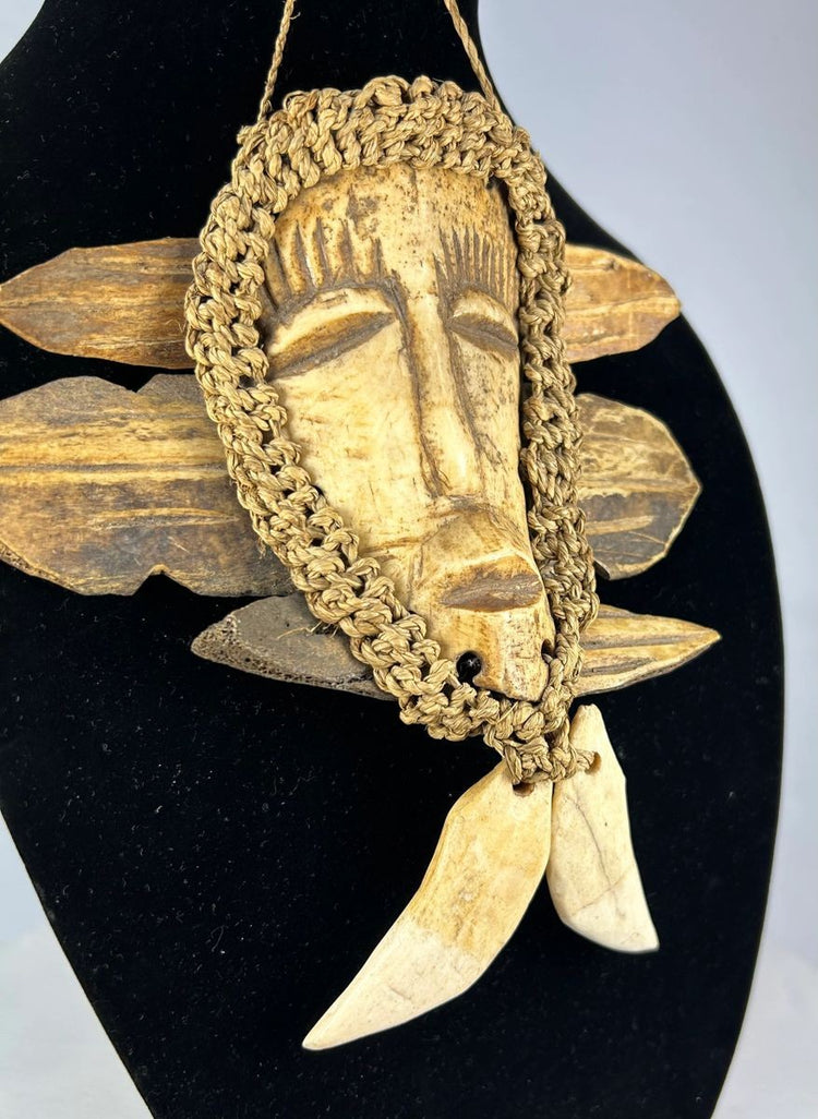 Mid-century Congo Lega pendant mask with carved face and fiber details