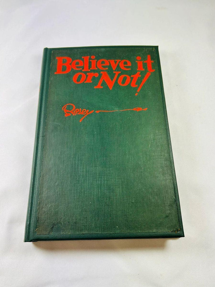 Detailed view of Robert Ripley’s autograph and personal note inside 1929 Believe It or Not! first edition hardcover.