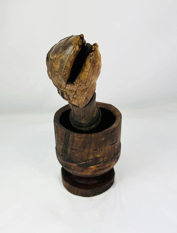 Antique wooden European mortar and pestle with intricately carved details
