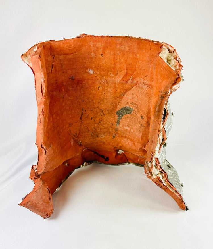 Flown NASA Space Shuttle insulation blanket with orange thermal backing and metallic fibrous silica surface, stamped April 1983 with serial number and manufacturer code, part of the Thermal Protection System for the Shuttle’s thrust vector control assembly.