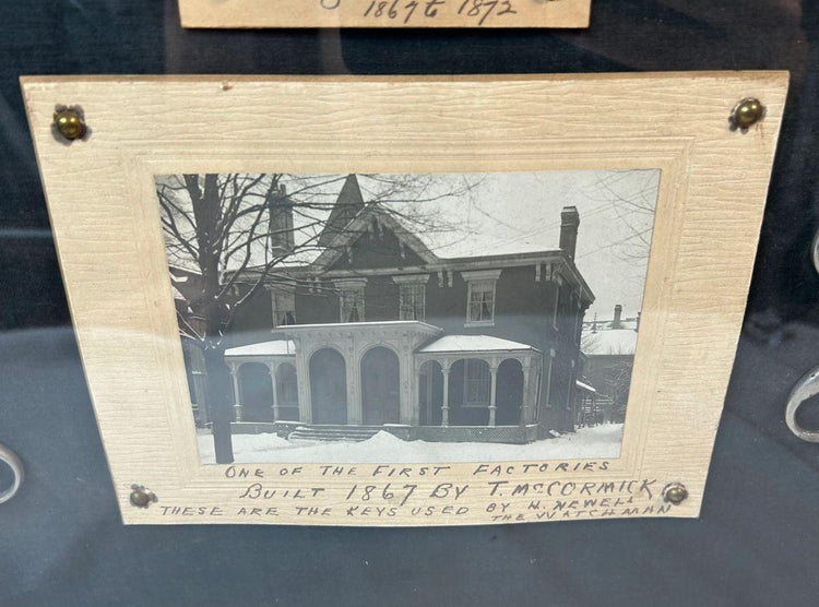 Antique iron keys in wooden shadowbox with historical photograph