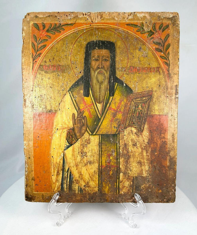 18th-century Russian Orthodox icon of a saint holding a Gospel book, hand-painted on wood with gilt background and aged patina.