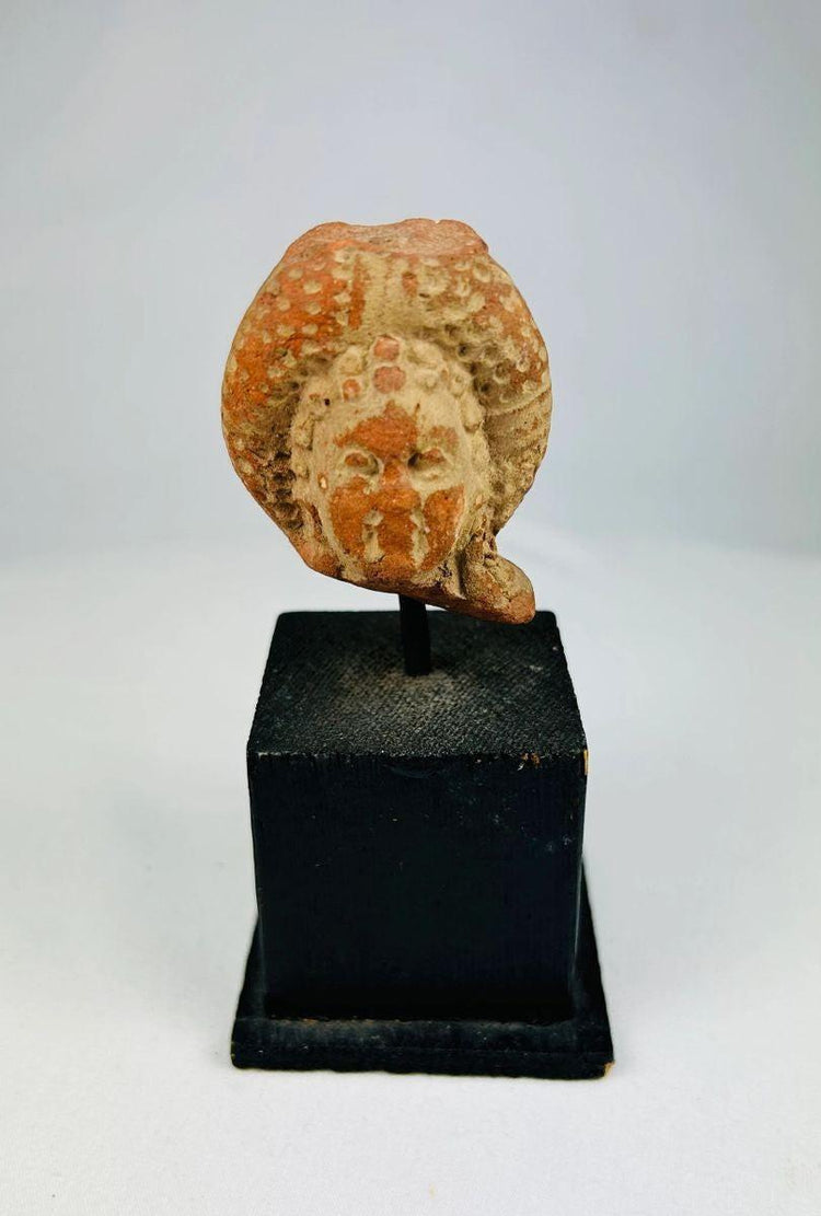 Fragment of ancient Mesoamerican terracotta figure with visible pigment remains