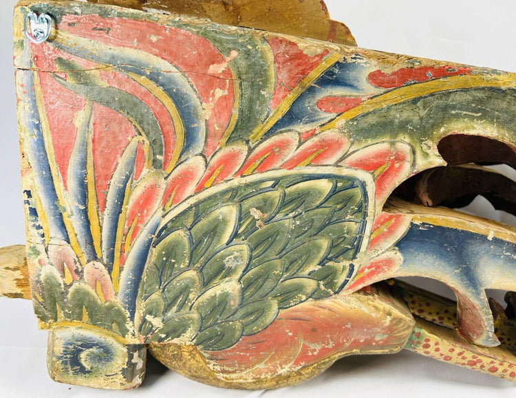 Detail view of Qing Dynasty phoenix relief showing carved feathers and vibrant red, blue, and green polychrome pigments on aged camphor wood – Relic and Rarity.