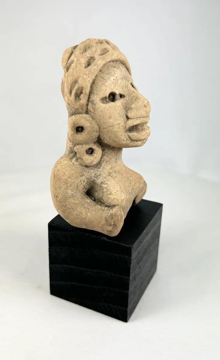 Ancient terracotta female sculpture from West Mexico mounted on a black museum-style base