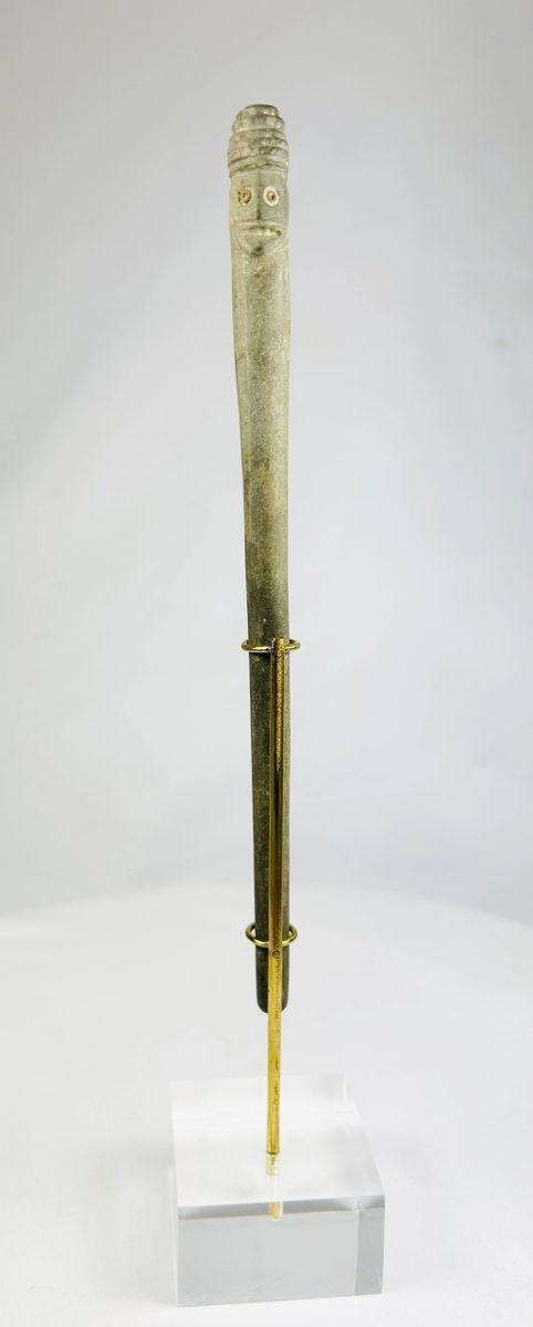 Tall ritual stone object from ancient Bactria, carved with two human faces and exhibiting burial patina.