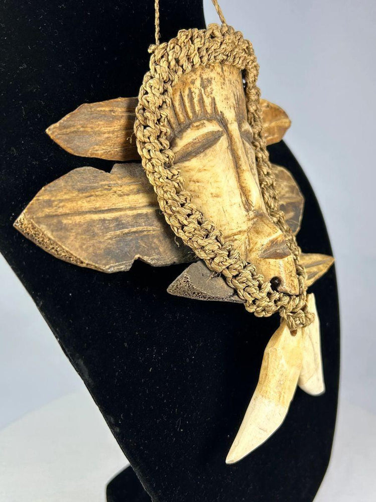 Lega pendant mask with braided fiber collar and wooden backing Congo