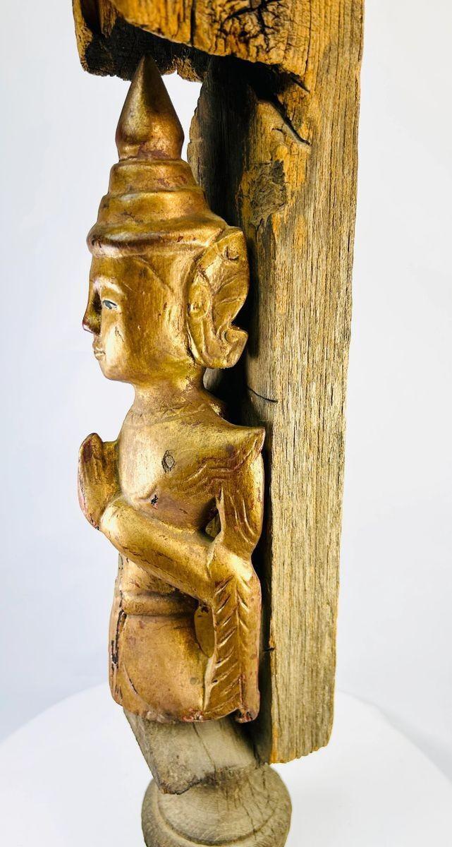Historic Burmese monastery finial with carved Buddha and architectural detailing