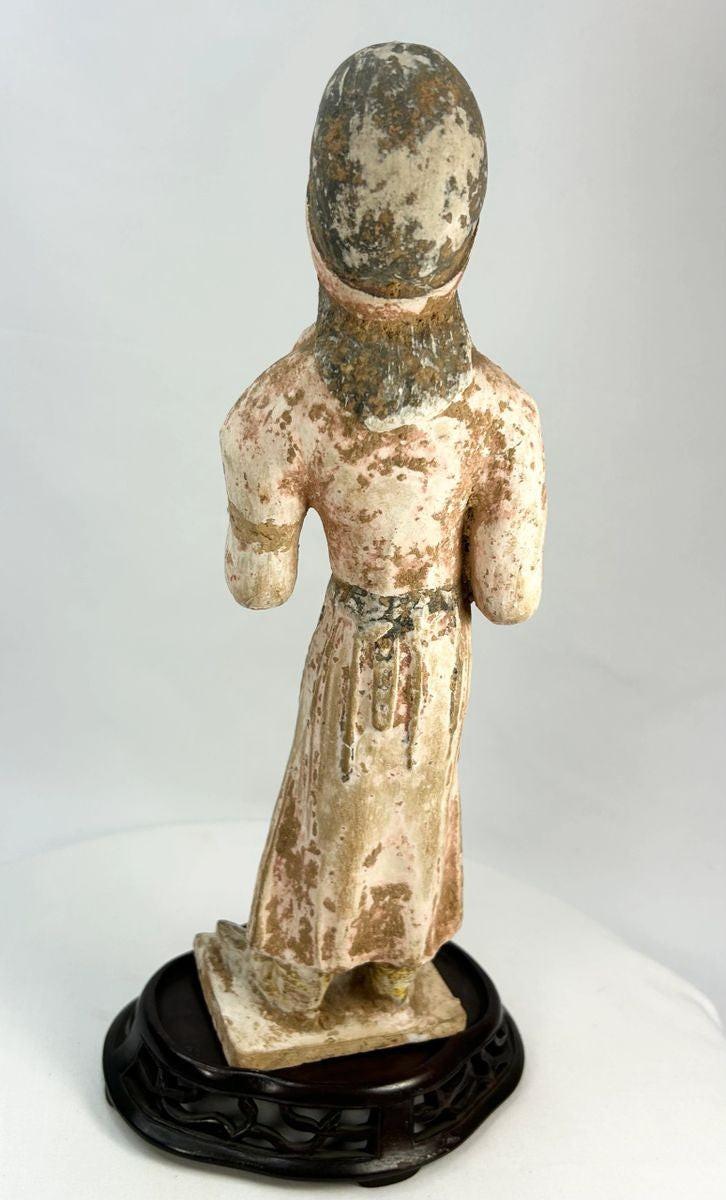 Chinese Tang Dynasty funerary figure showing traditional hairstyle, clasped hands, and elegant drapery