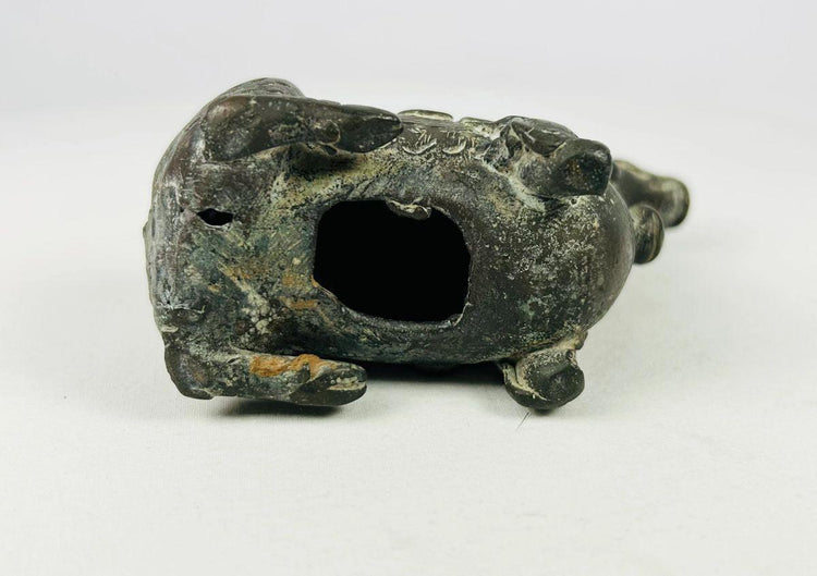 Underside of bronze Qilin censer showing hollow interior, age patina, and wear consistent with ritual incense use.