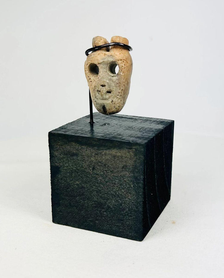 Ritual bone mask amulet from Colima or Nayarit tradition, mounted on custom display stand