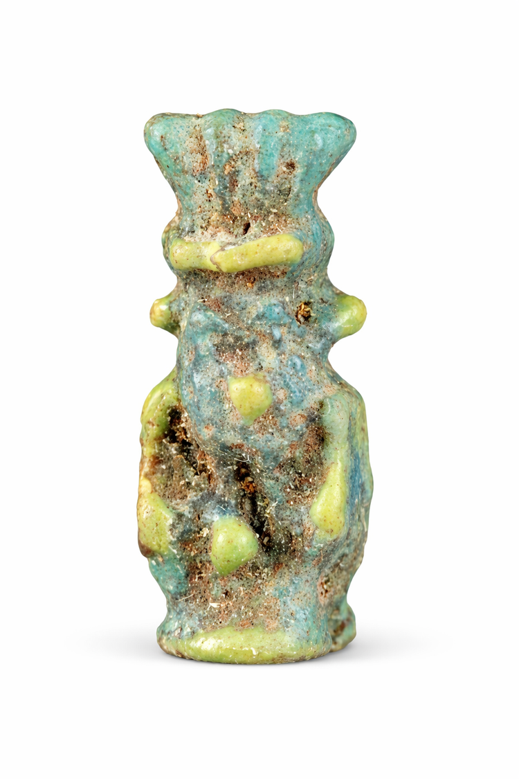 Ancient Egyptian Bes charm in glazed faience used as a protective talisman.