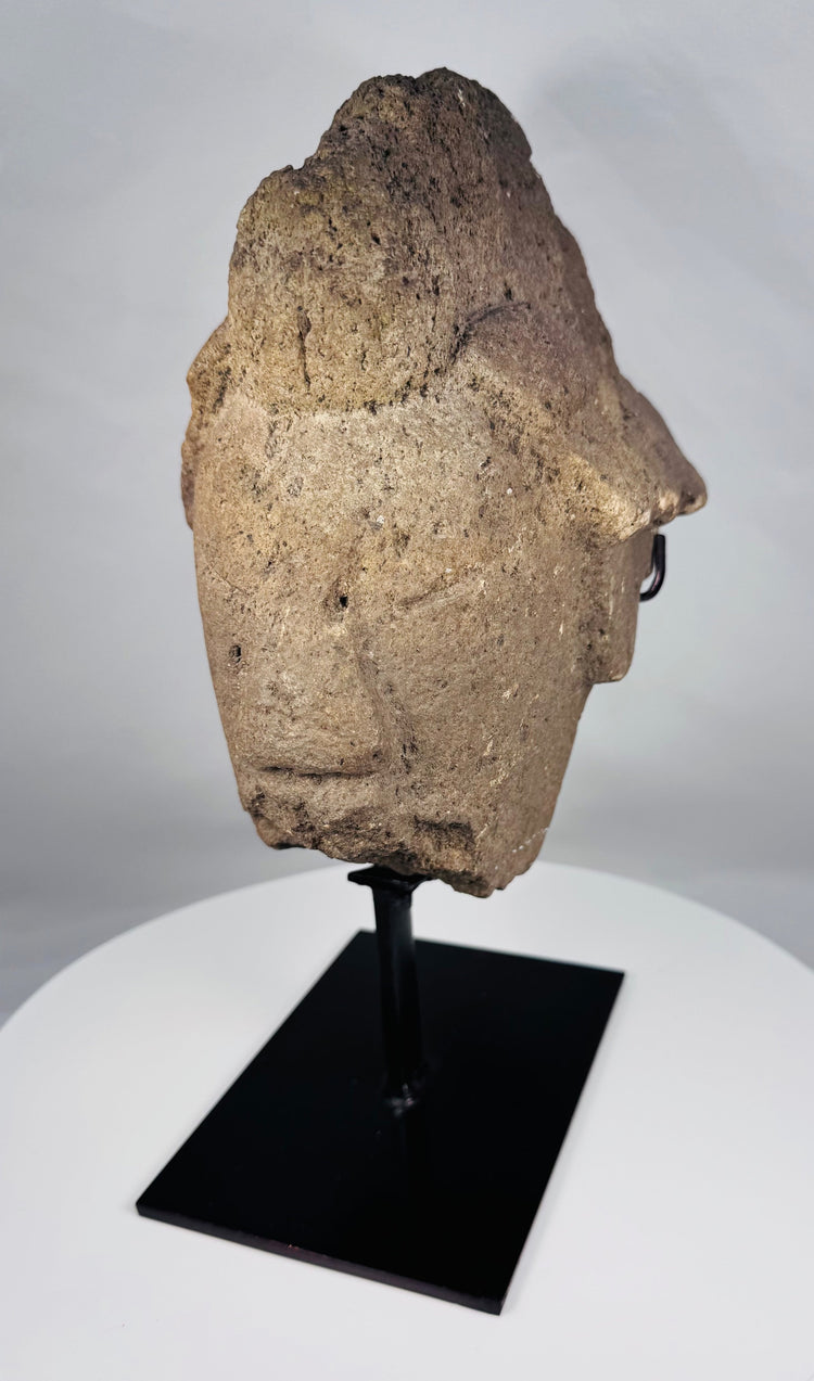 Stylized African stone face fragment with geometric features and headdress
