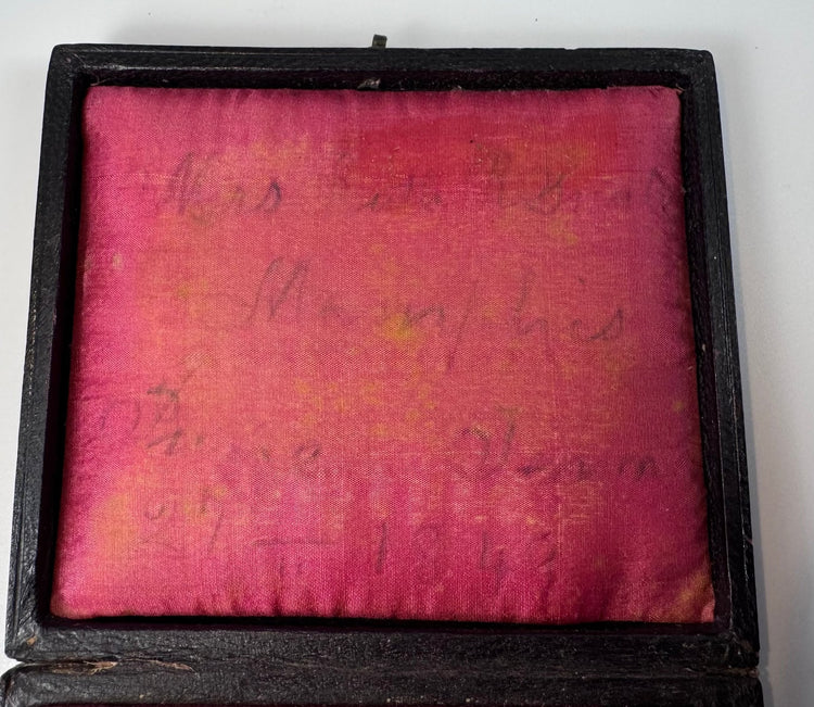 Victorian portrait of a mature woman preserved beneath a gilt brass mat