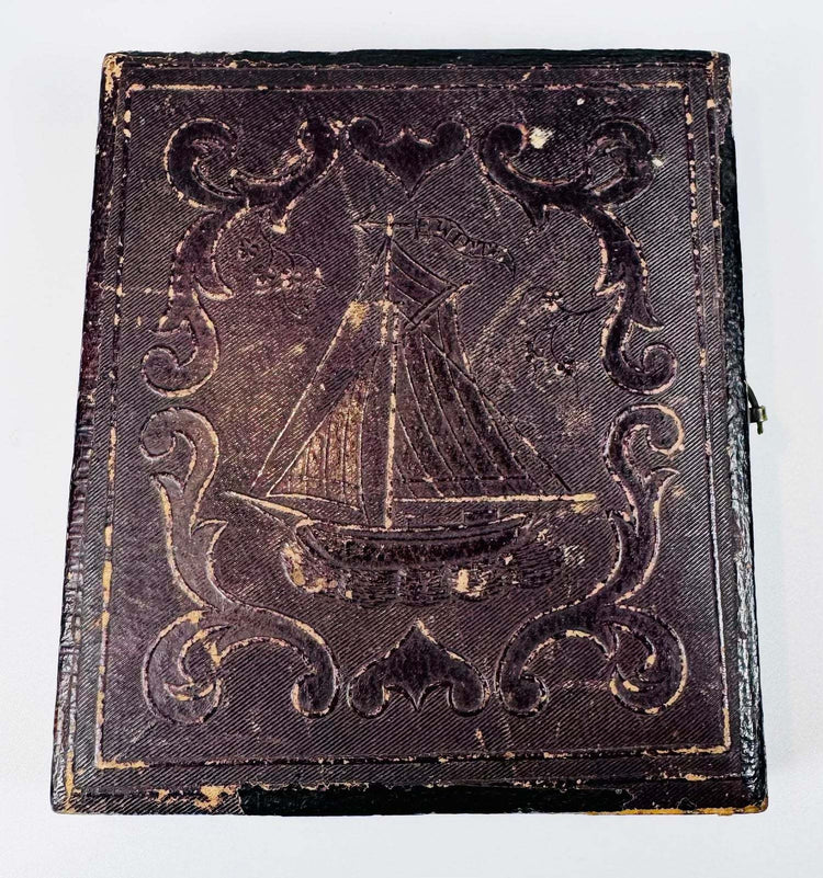 Early American daguerreotype housed in a crimson velvet-lined leatherette case