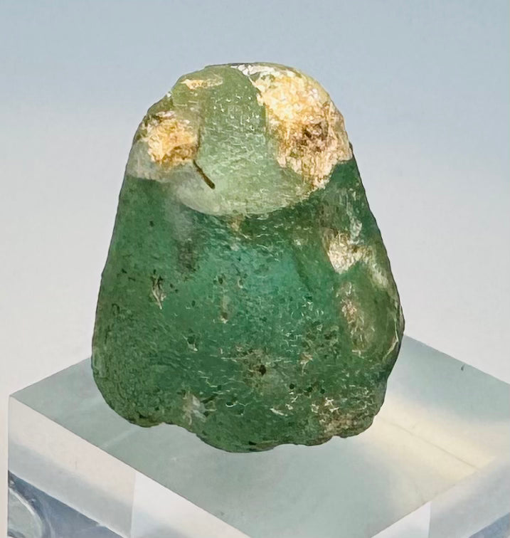 Iron Age glass seal with pale deposits, iridescence, and worn engraved design