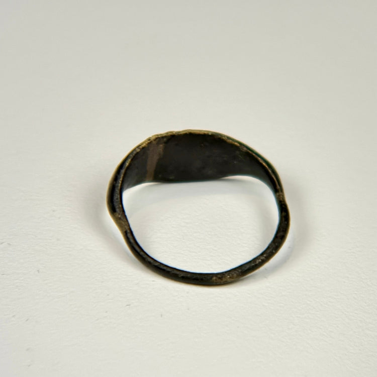 Ancient bronze finger ring featuring a symbolic bull associated with strength, fertility, and power
