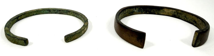 Ancient bronze and iron bangle pair with green and dark brown patination dating to the Roman-era period