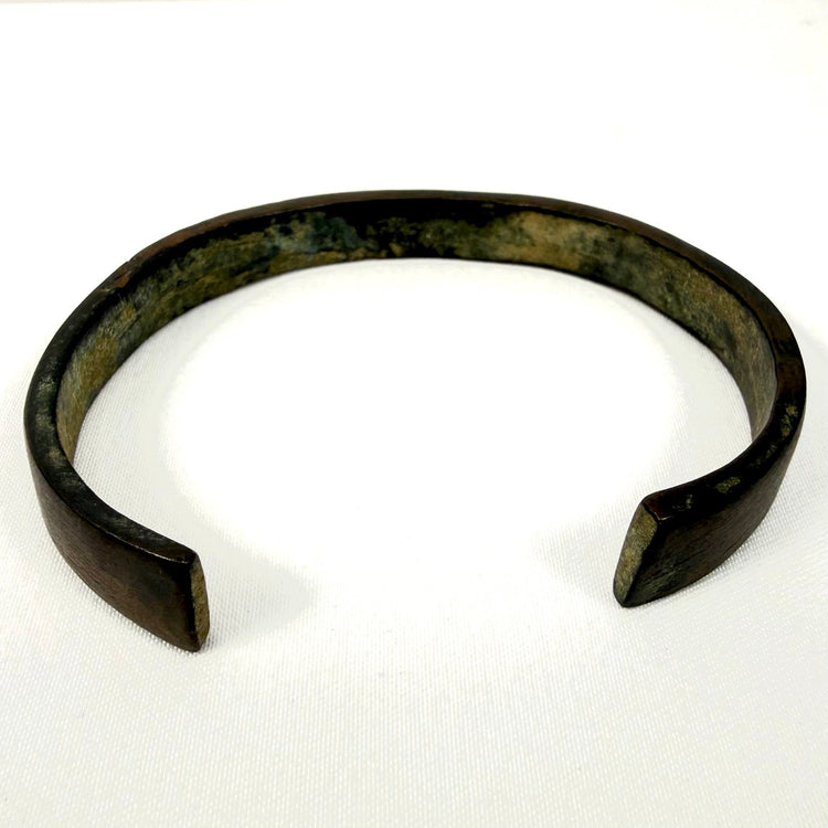 Archaeological iron bracelet with broad open cuff form and naturally weathered dark surface