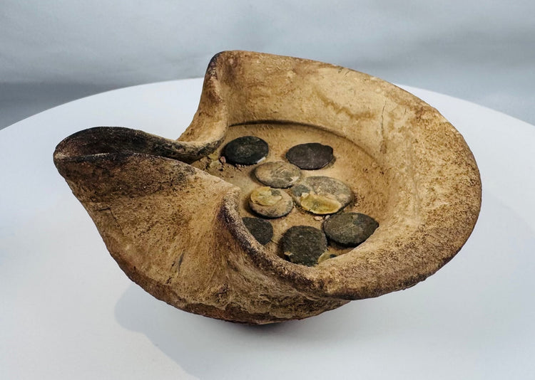 Ancient Punic-Roman terracotta oil lamp displaying folded rim construction and bronze coins