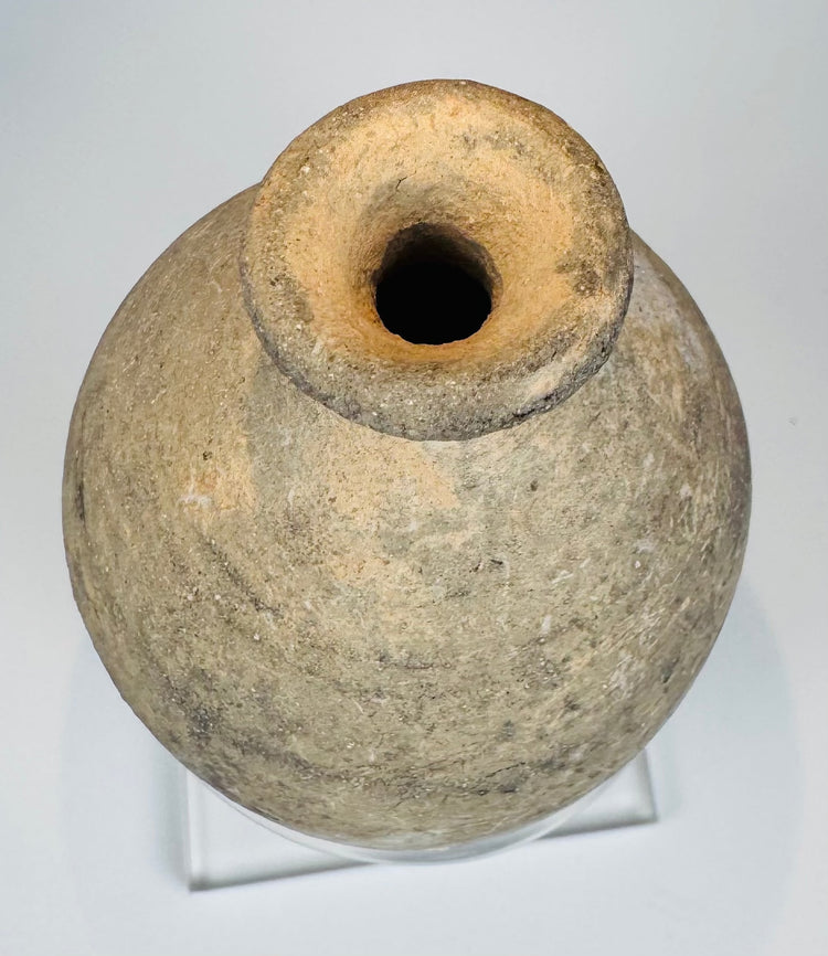 Small Roman Byzantine pottery bottle displayed on a clear acrylic stand