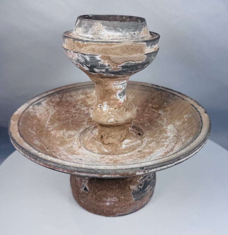 Near Eastern terracotta pedestal lamp or offering vessel with aged encrustation