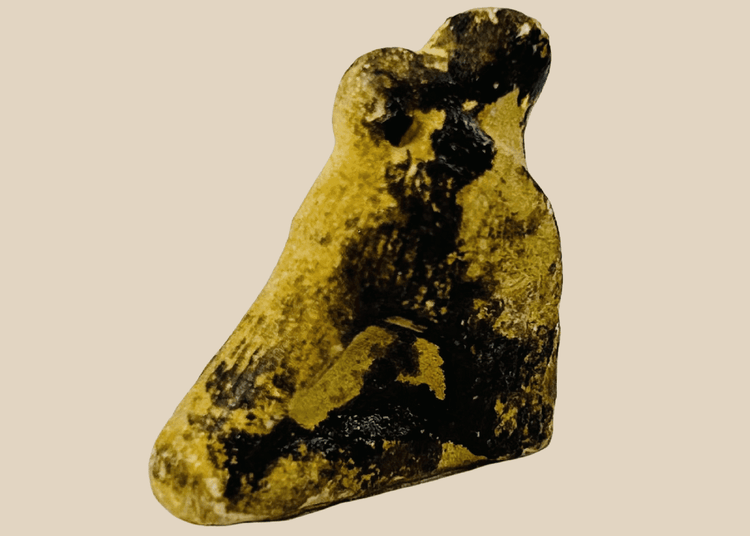 Ancient Egyptian carved stone falcon amulet associated with the god Horus from the Late Period.