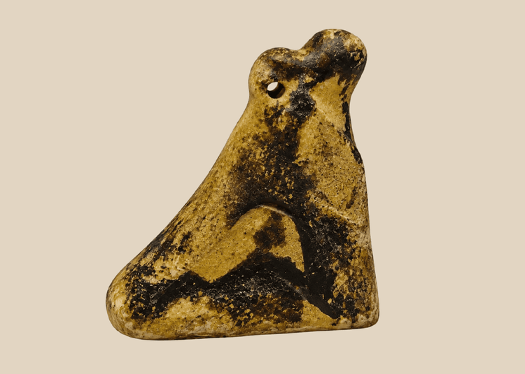 Ancient Egyptian carved stone falcon amulet associated with the god Horus from the Late Period.