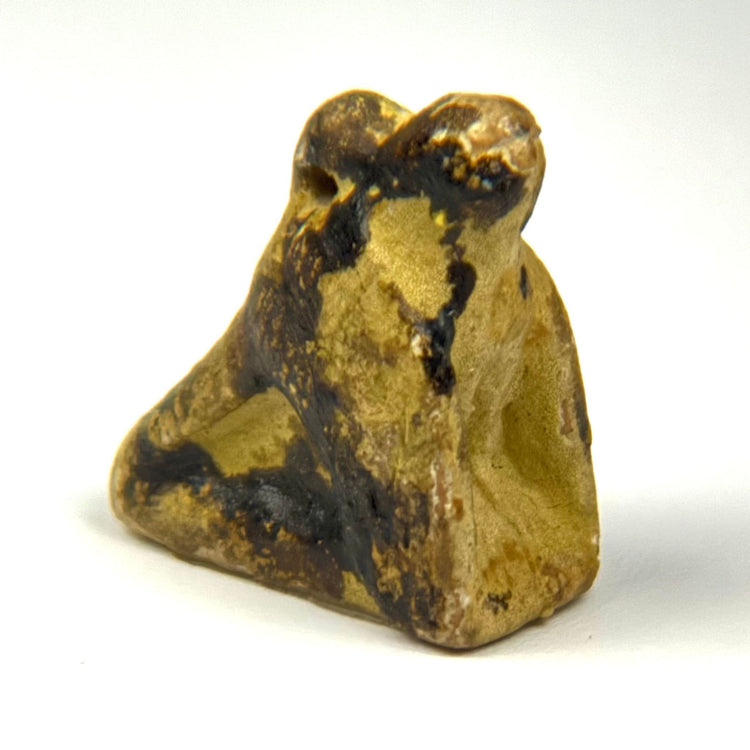 Small Ancient Egyptian Horus falcon amulet carved in stone with crouching posture and intact suspension hole, 664–30 B.C.