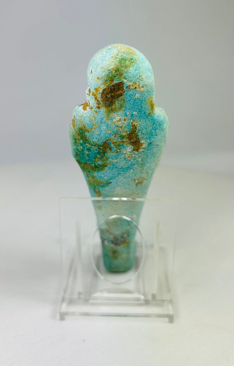 Reverse side of ancient Egyptian faience ushabti with turquoise glaze and faint back pillar inscription.