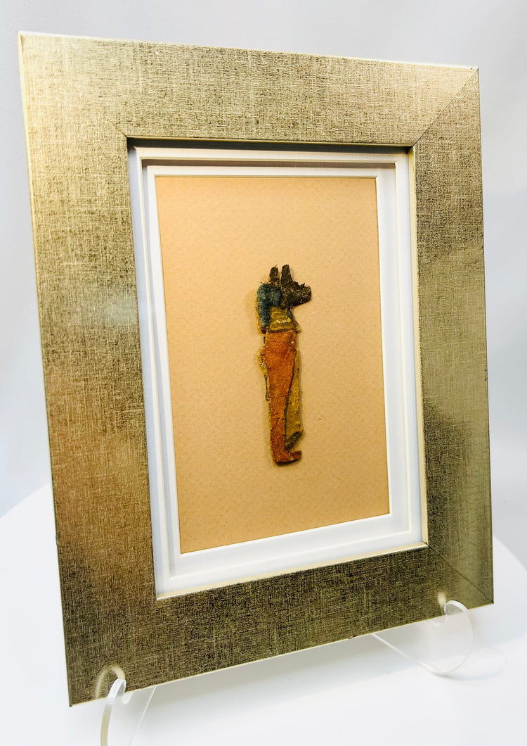 Egyptian cartonnage fragment depicting Anubis with jackal head and vivid colors