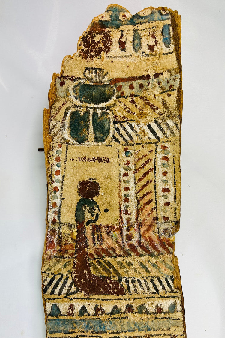 Upper section close-up of coffin panel with large blue-green scarab and kneeling figure before shrine