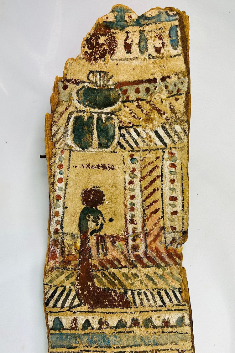 Upper section close-up of coffin panel with large blue-green scarab and kneeling figure before shrine