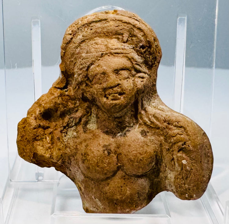 Ancient Egyptian Ptolemaic terracotta fragment, circa 200–100 BCE, preserving the face and upper torso of a female figure.