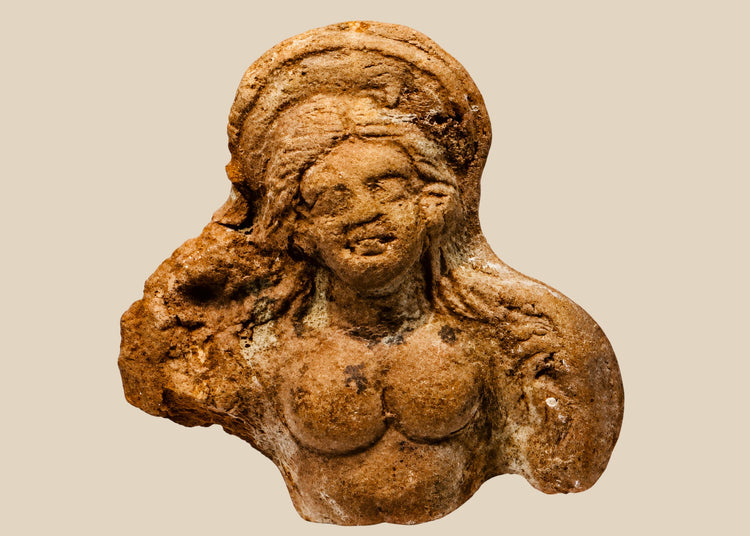 Terracotta fragment depicting partial female figure with upper torso and facial features, Ptolemaic Egypt, circa 200–100 BCE, showing Hellenistic-Egyptian artistic fusion and ancient patina.