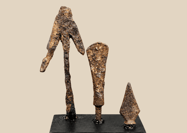 Group of three ancient and medieval iron projectile points on black display bases