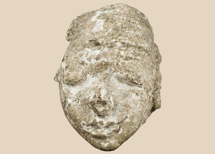 Ancient Gandharan Buddhist stucco head fragment mounted on a wooden display base