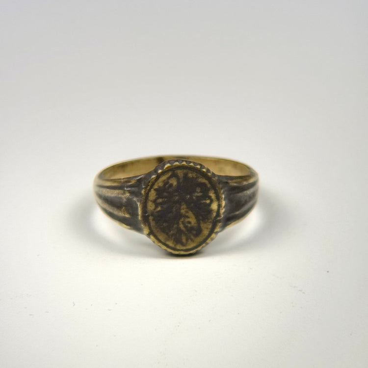 Historic gold-gilded bronze ring dating to circa 300–600 CE with engraved botanical decoration